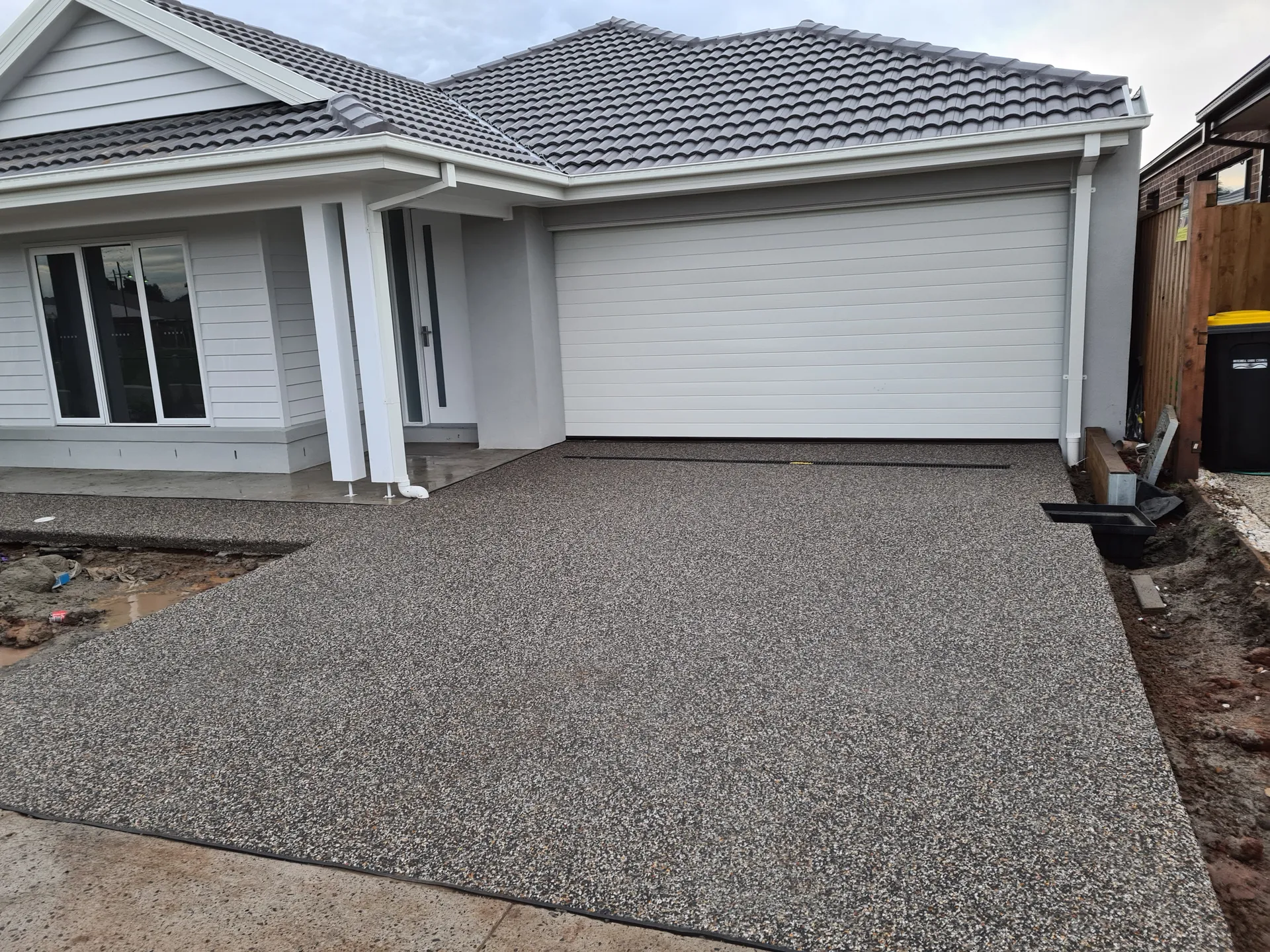 Large exposed aggregate outdoor entertaining area and driveway